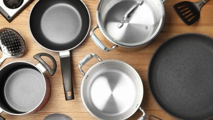 Flat lay composition with clean cookware on wooden background