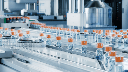 Glass vials on a production line representing pharmaceutical testing in Intertek Pharmaceutical Services India laboratory