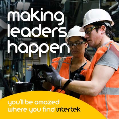 Two people wearing personal protection equipment while reading from a tablet